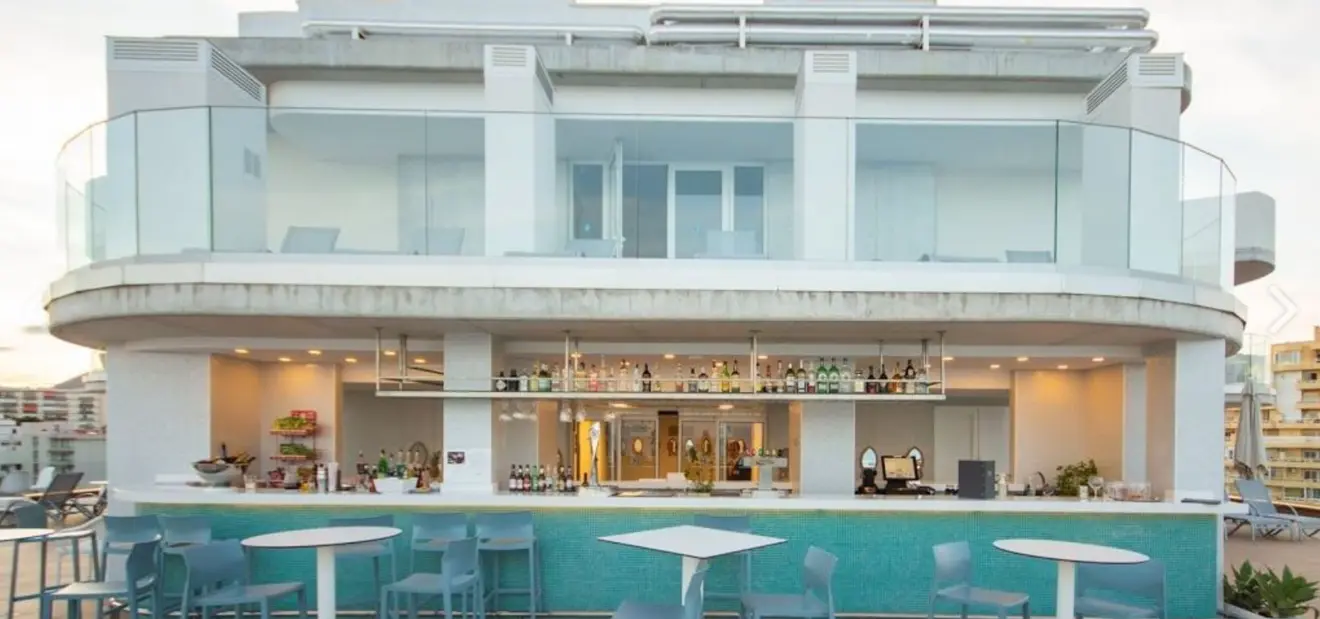 Modern white rooftop bar building above the seafront at Celeste Skybar, Benalmadena