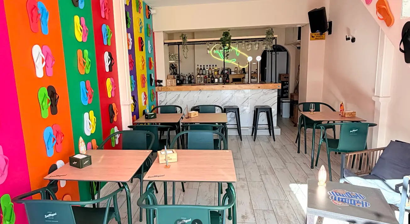 Colourful flip flop mural and turquoise chairs in the dining room at Flip Flop Bar, Benalmadena