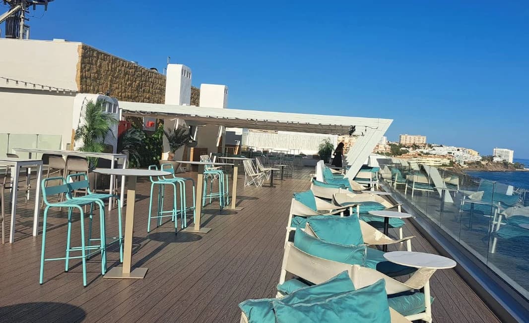 Blue bar stools and high tables along the seafront terrace at Nix Sky Bar, Benalmadena