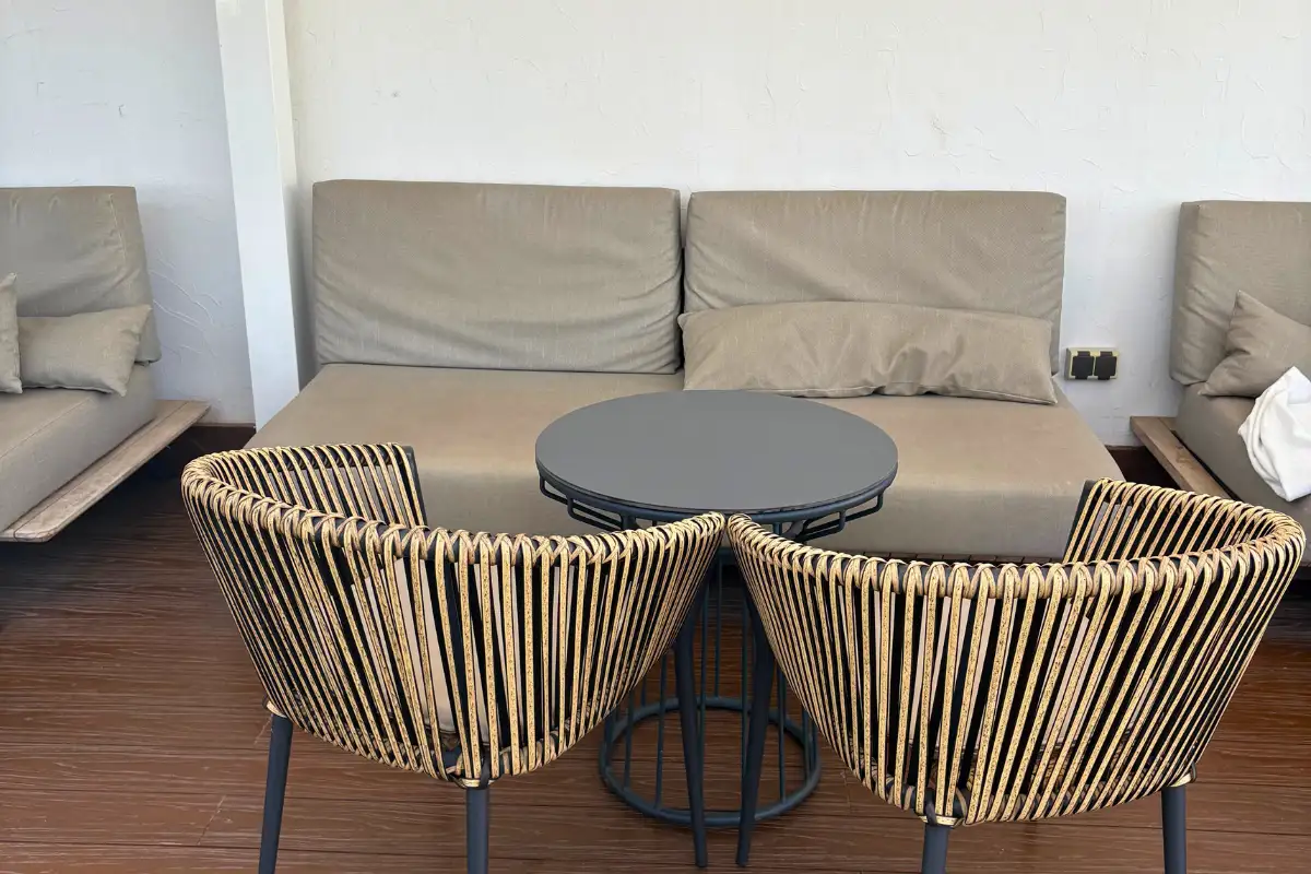 Rope lounge chairs around a low table at Aurea rooftop in Malaga