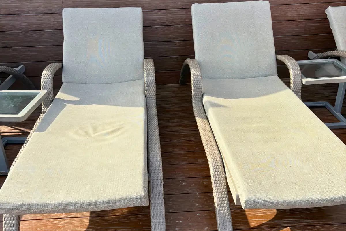 Two cushioned sunbeds with towels beside the Aurea rooftop pool in Malaga