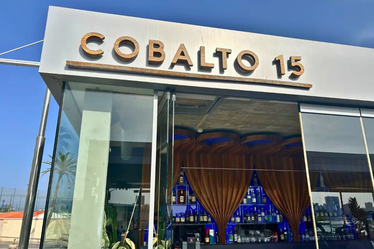 Illuminated Cobalto 15 sign above the glass entrance in Malaga