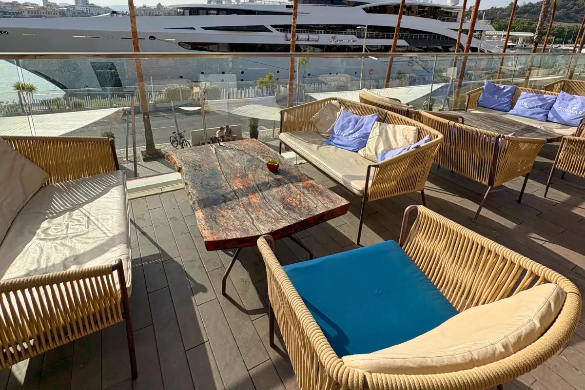 Woven lounge chairs and yachts beside the marina at Cobalto 15, Malaga