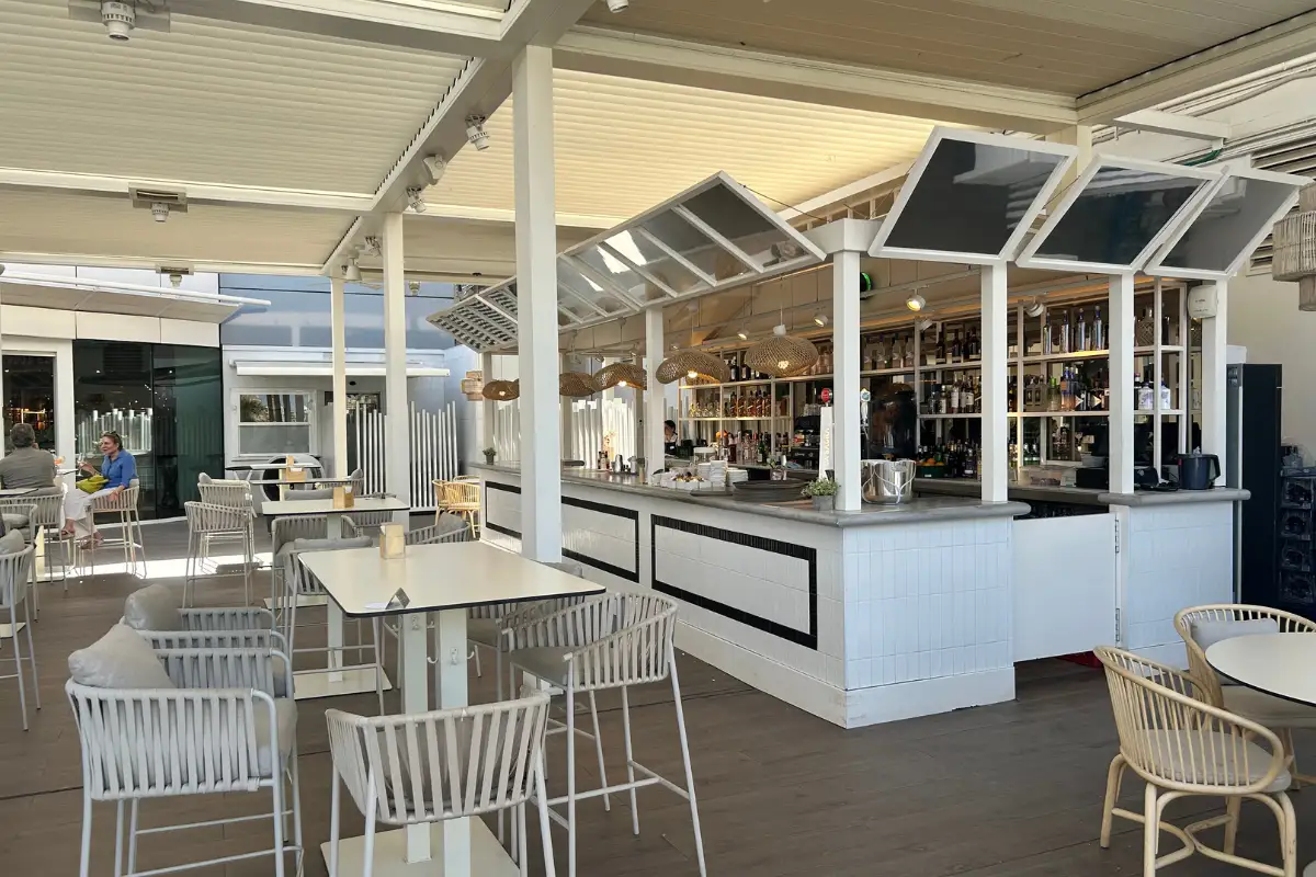 White rooftop bar counter under canopy at El Corte Ingles, Malaga