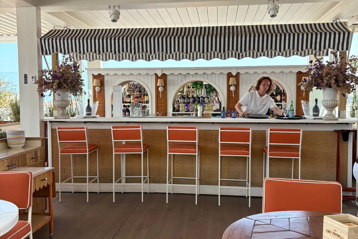 Orange bar stools and striped awning at the El Corte Ingles rooftop bar, Malaga