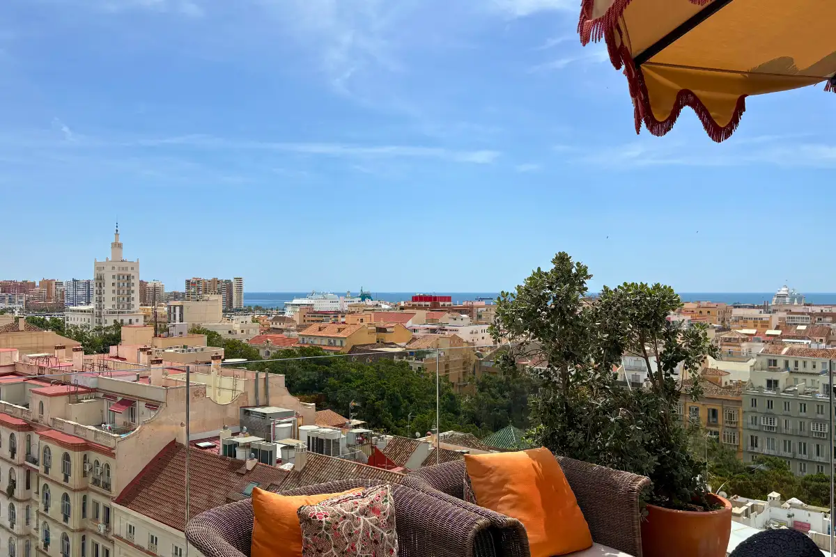 Cushioned sofa and city views from the H10 Croma rooftop terrace, Malaga