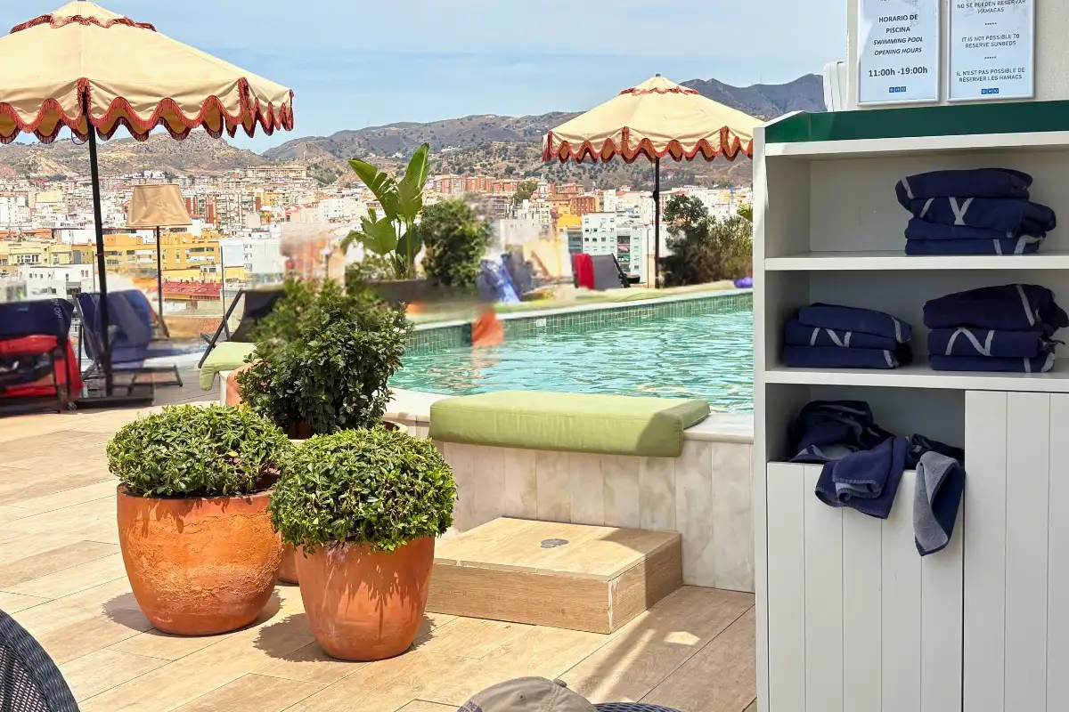 Towel station and pool with city views at H10 Croma rooftop, Malaga