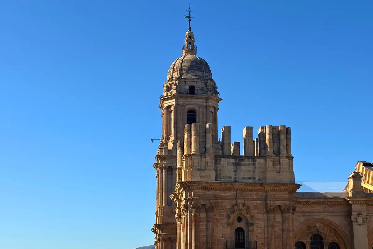 Close view of Malaga cathedral's domed tower from Molina Lario rooftop