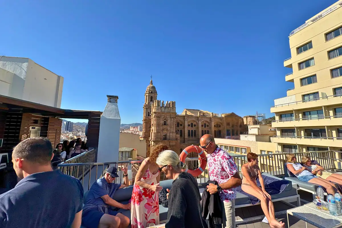 Guests by the rooftop pool with cathedral views at Molina Lario, Malaga