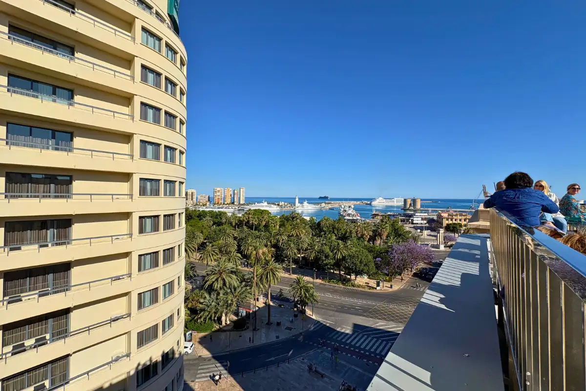 Visitor at the railing overlooking Malaga port from Molina Lario rooftop