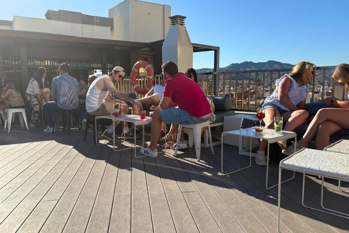 Guests at terrace tables with mountain views at Hotel Molina Lario in Malaga