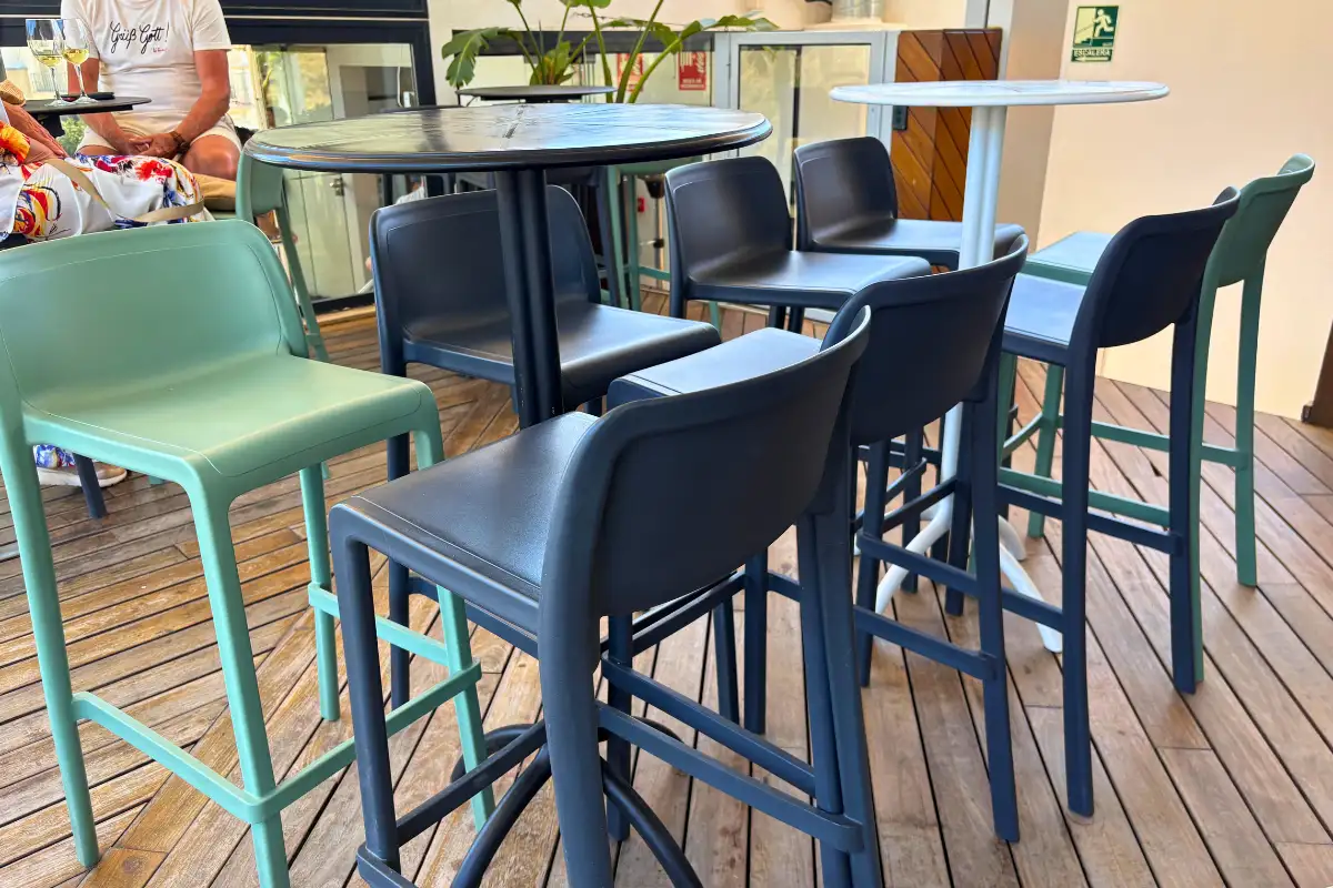 Black and green bar stools on the wooden deck at La Terraza de Alcazaba in Malaga