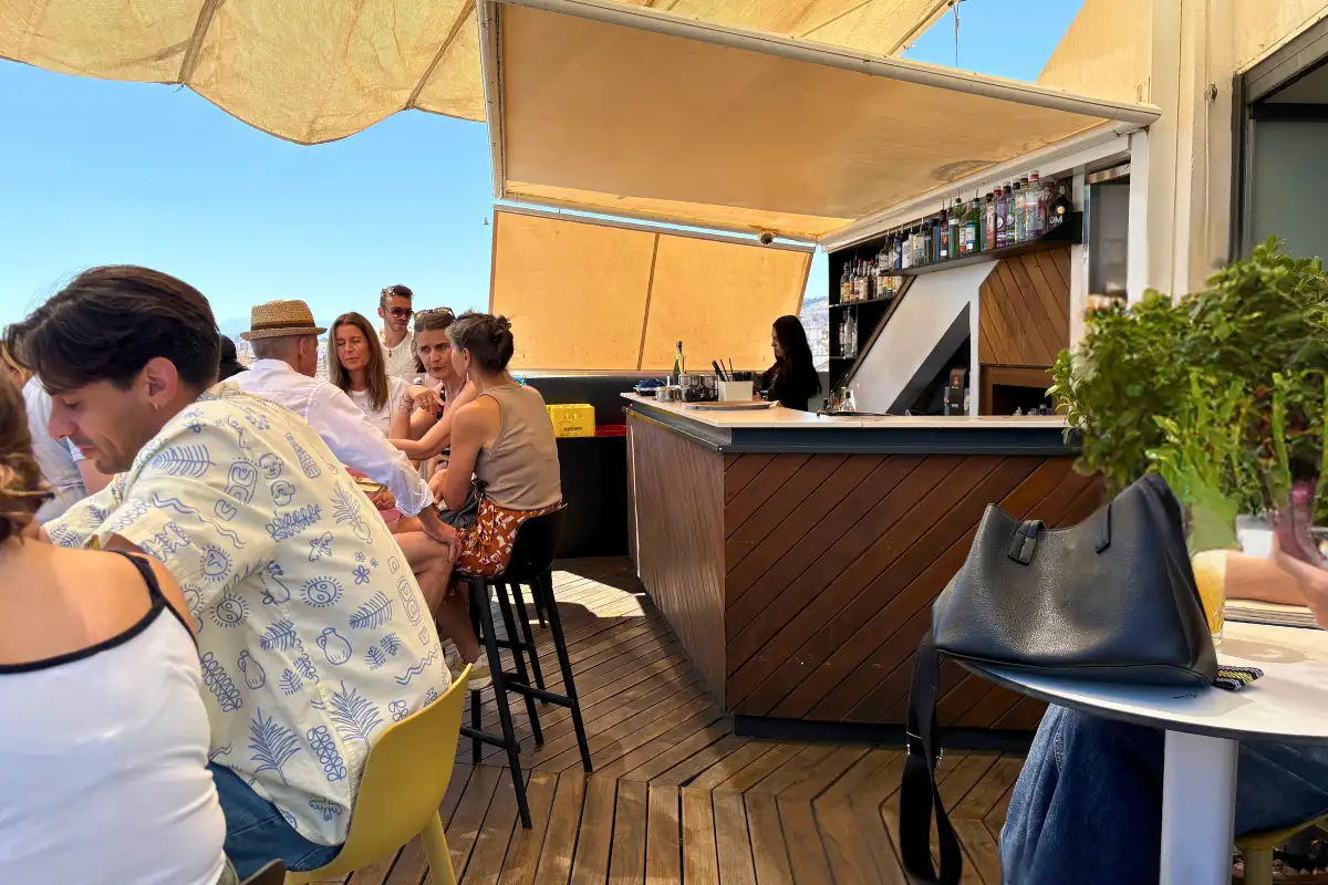 Guests seated under an awning at the busy bar of La Terraza de Alcazaba in Malaga
