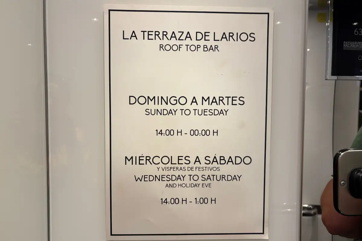 Opening hours sign for the rooftop bar at La Terraza de Larios in Malaga