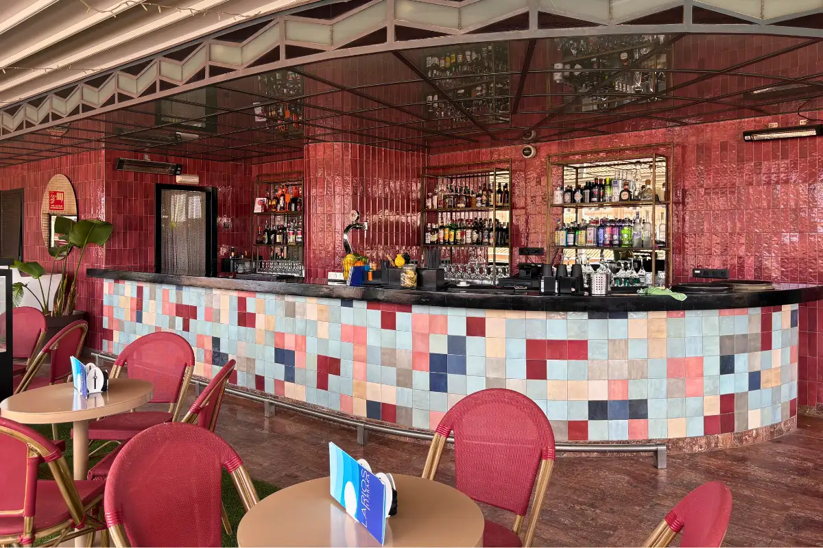 Colourful tiled bar counter with red chairs at La Terraza de Larios in Malaga