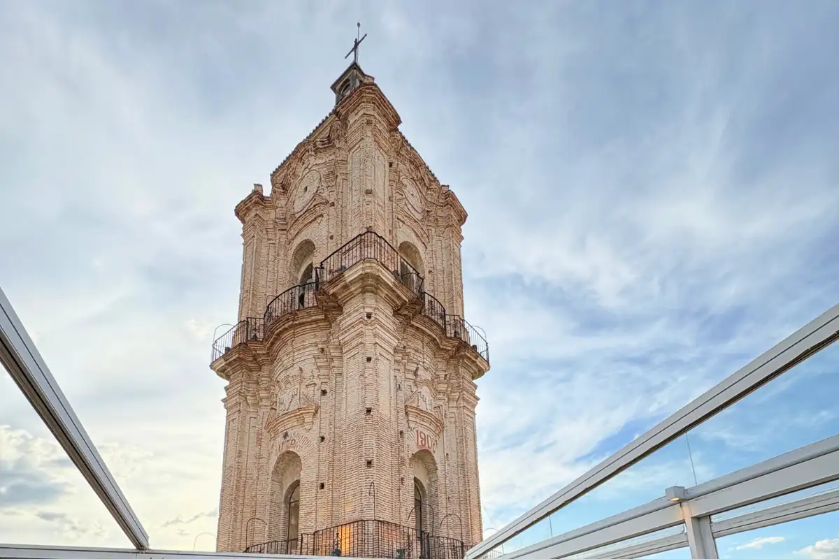 Ornate baroque church tower seen from La Terraza de San Juan rooftop in Malaga