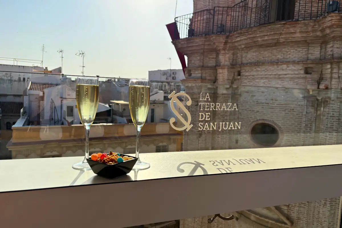 Cava glasses and olives overlooking rooftops at La Terraza de San Juan in Malaga