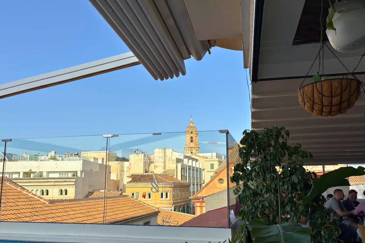 View over Malaga rooftops and a church dome from La Terraza de San Juan terrace