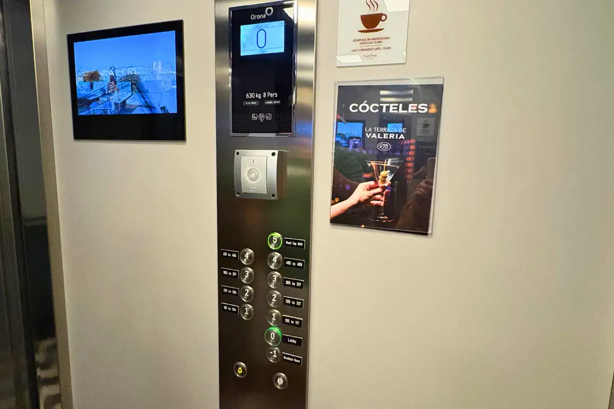Lift panel with a cocktails poster heading up to La Terraza de Valeria in Malaga