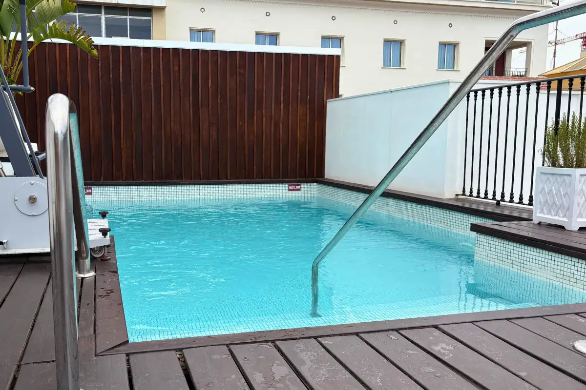 Rooftop plunge pool framed by wood decking at La Terraza de Valeria in Malaga
