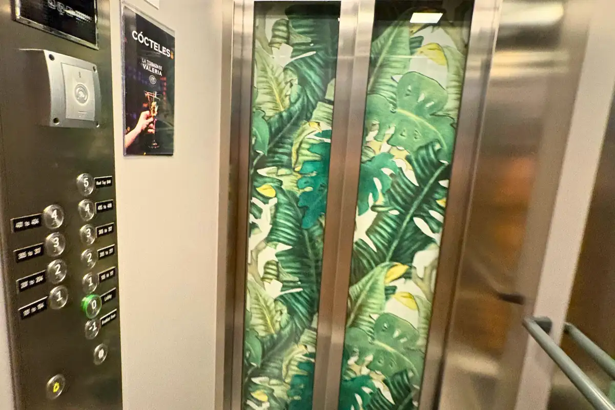 Lift lined with tropical leaf print panels at La Terraza de Valeria in Malaga