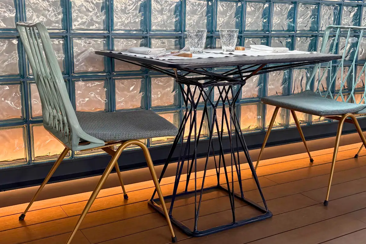 Bistro table for two beside the glass railing at La Terraza Solecio in Malaga