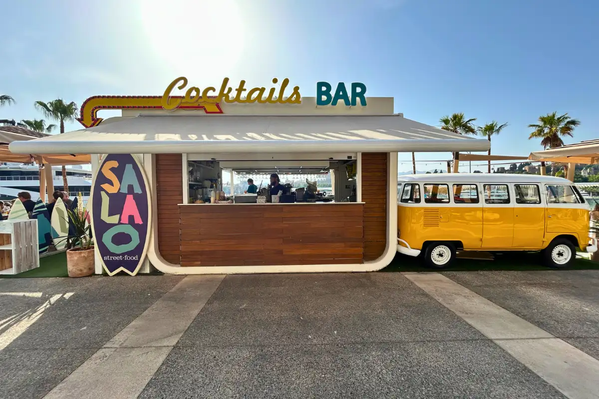 Surf-themed Cocktails Bar kiosk with vintage camper van at La Terraza Surfera in Malaga
