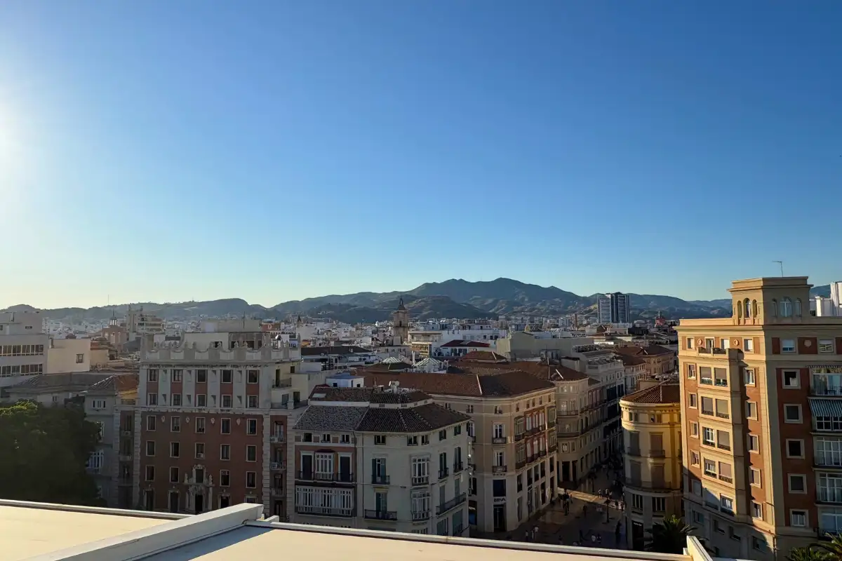 Malaga cityscape stretching to the mountains from Lolita Skyview rooftop