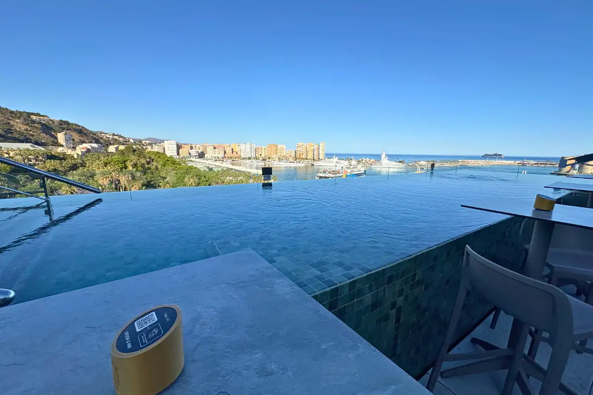 Infinity pool and bar stools overlooking the port at Lolita Skyview in Malaga