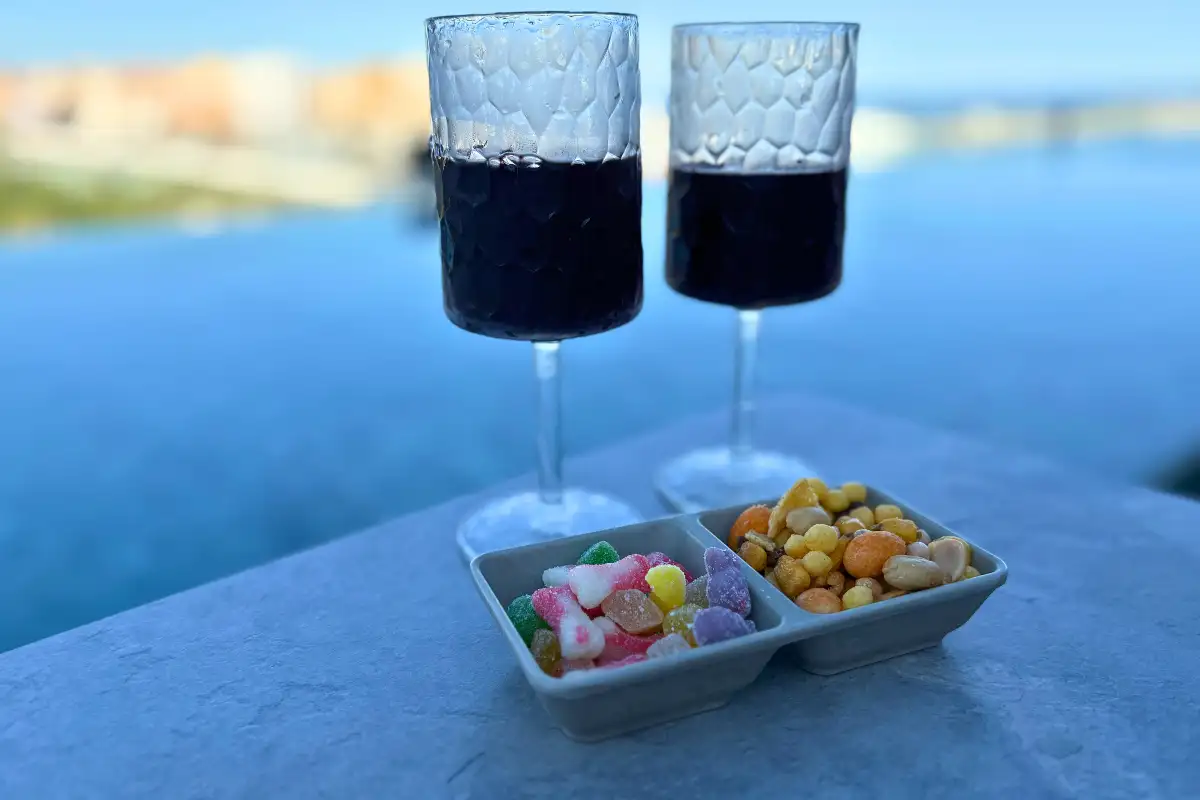 Red wine and bowls of snacks overlooking the sea at Lolita Skyview, Malaga