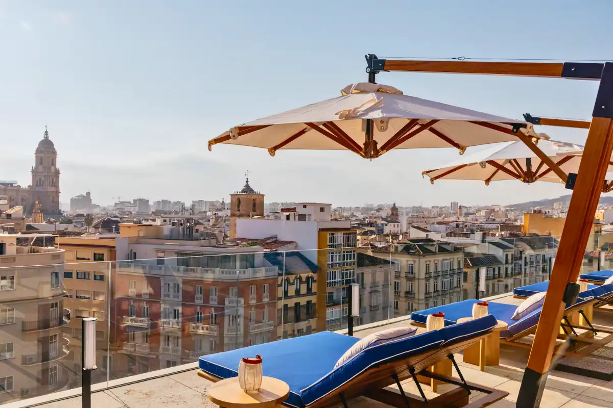 Blue sun loungers and parasols overlooking Malaga cathedral at Canitas Maite, ME Malaga