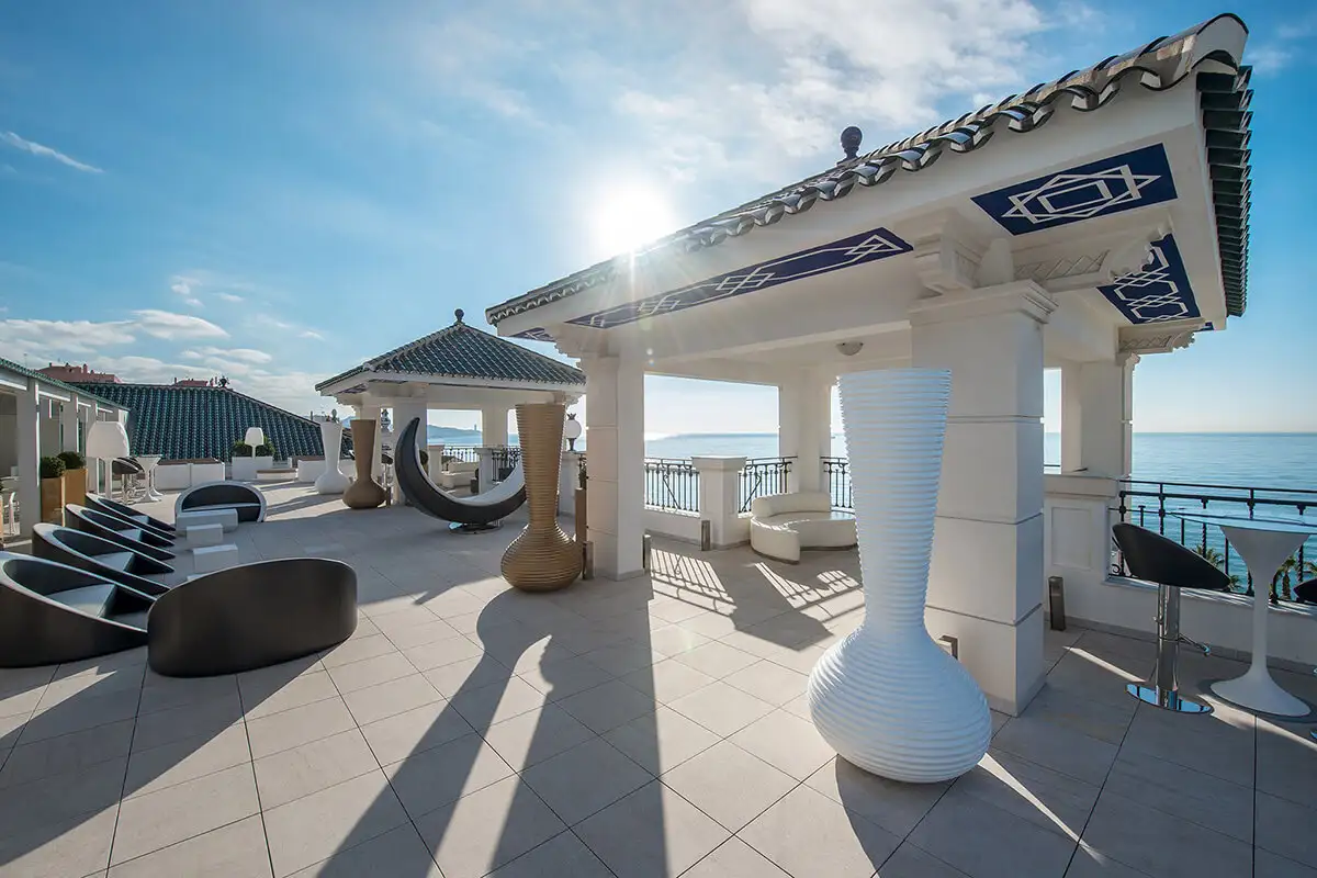 Sunlit terrace with gazebo and loungers facing the sea at Media Luna, Gran Hotel Miramar, Malaga
