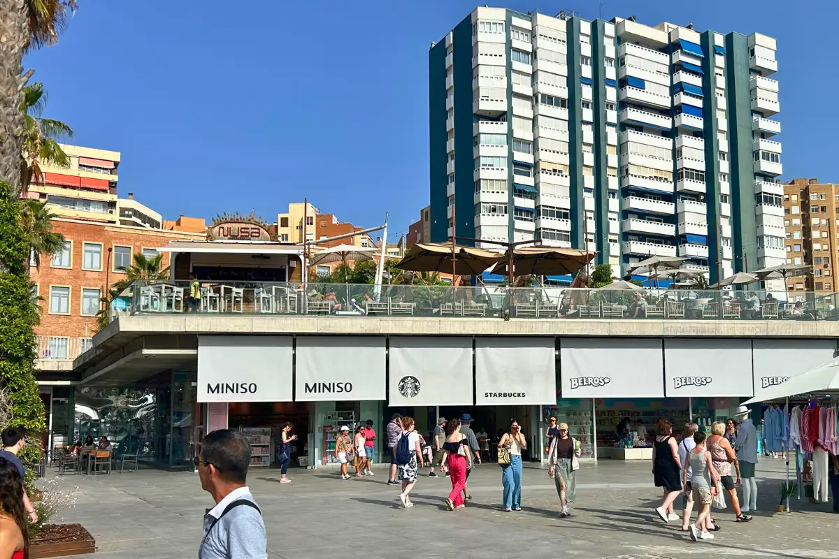 Pedestrian plaza outside the harbour with shops near Nusa, Malaga