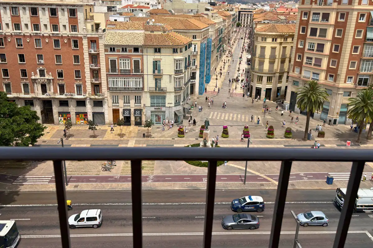 Balcony view over the Alameda Principal traffic and buildings at SOHO Boutique Equitativa, Malaga
