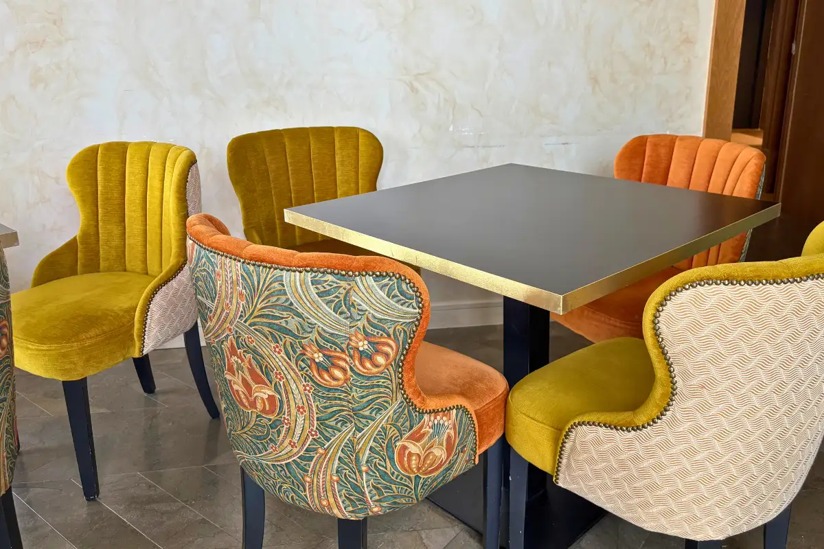 Patterned velvet chairs around a dining table at SOHO Boutique Equitativa, Malaga