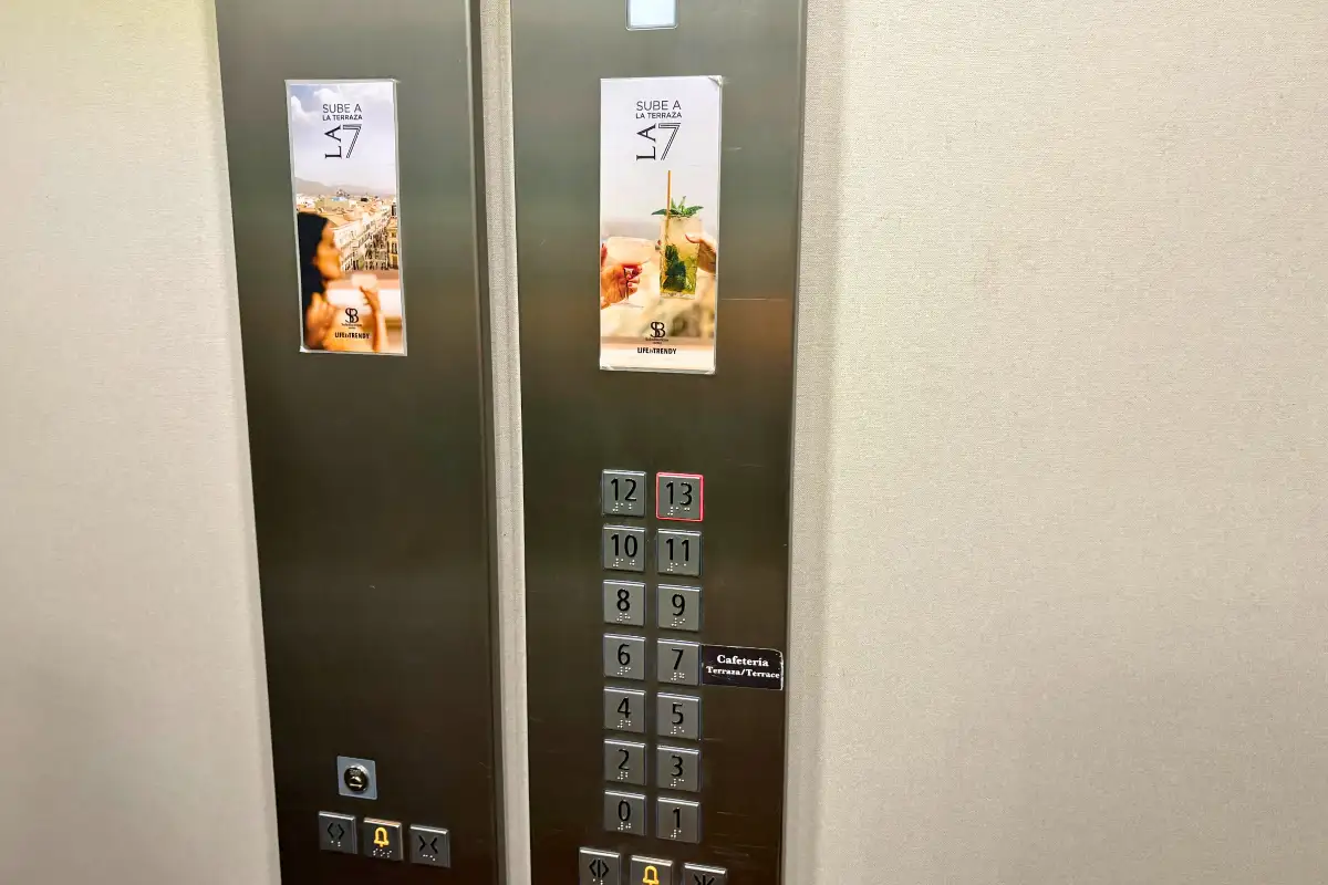 Lift with rooftop bar signs and button panel at SOHO Boutique Equitativa, Malaga