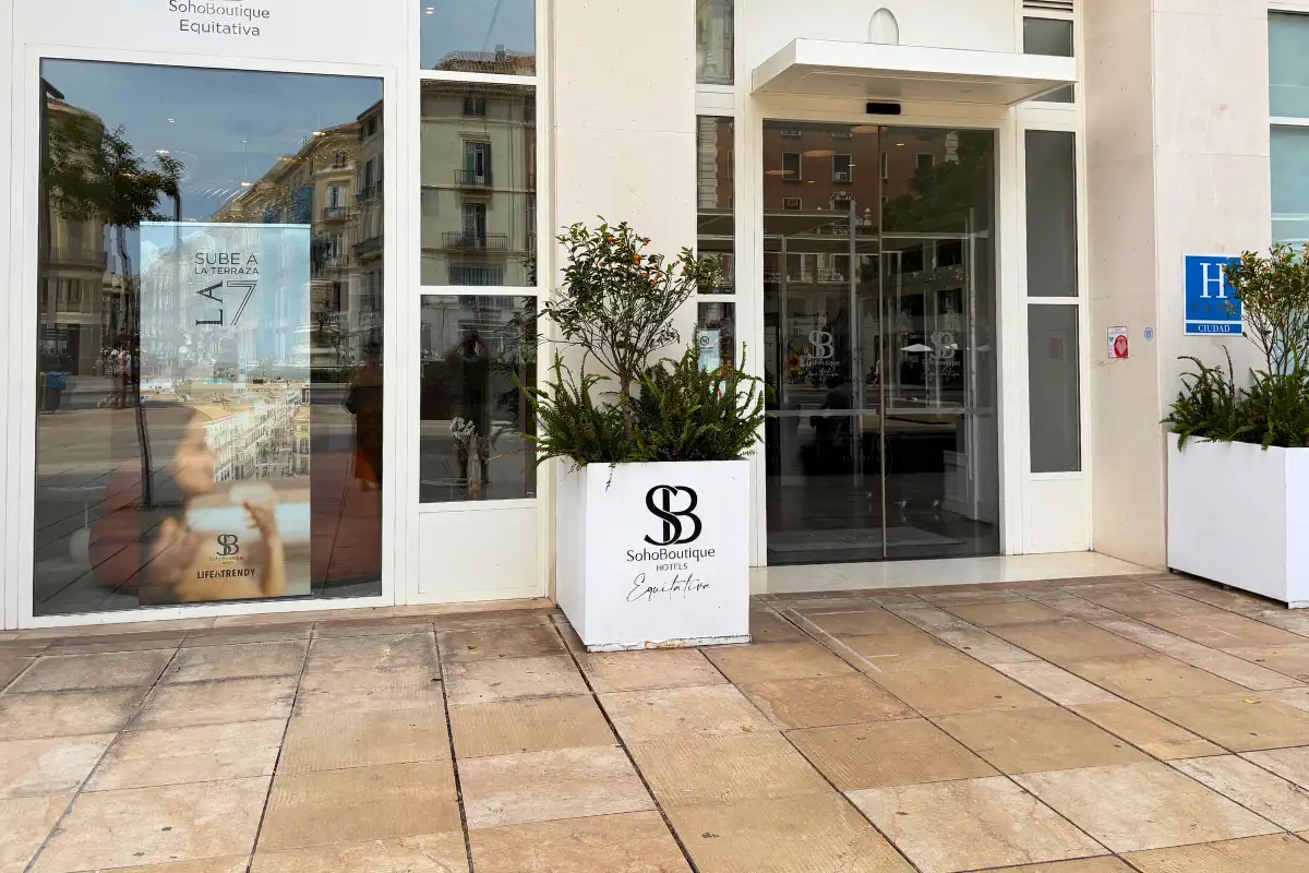 Glass entrance and planters at the front of SOHO Boutique Equitativa, Malaga