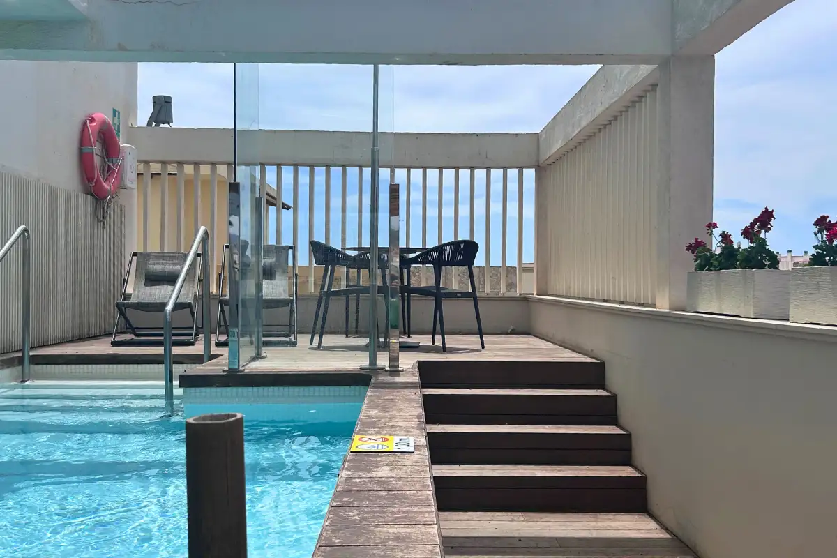 Small rooftop pool with high stools beside the deck at SOHO Boutique Equitativa, Malaga