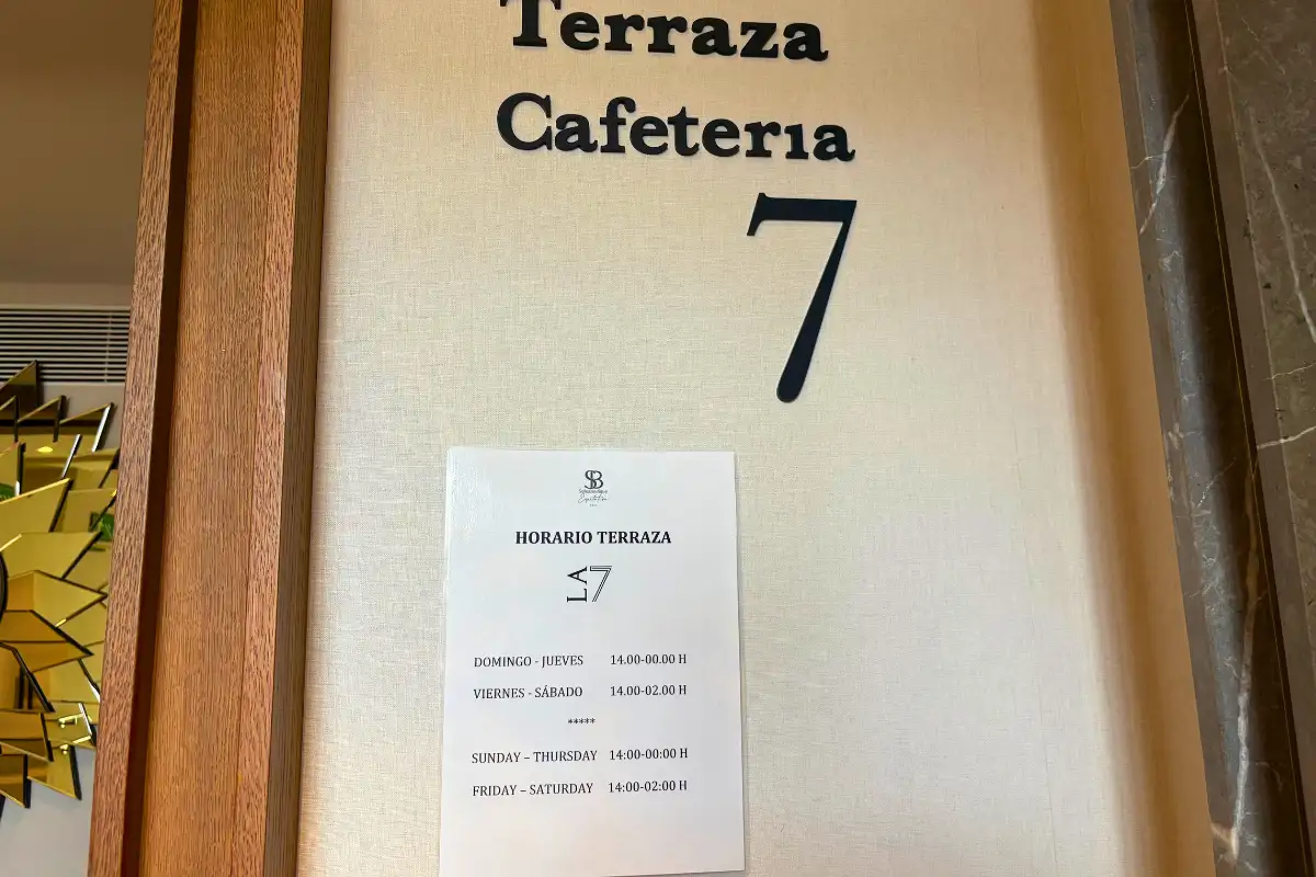 Terraza Cafeteria 7 wall sign with opening hours at Soho Boutique Equitativa in Malaga