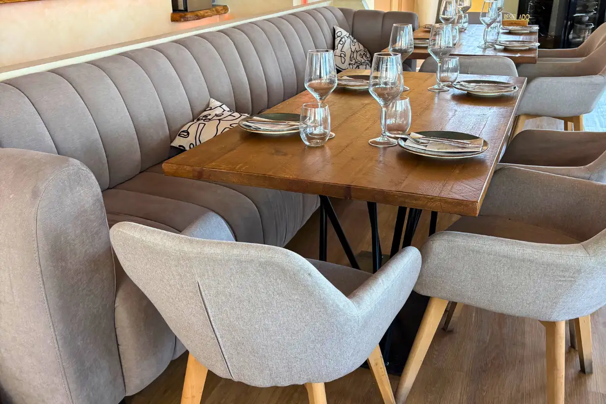 Set dining table with banquette seating inside Terraza Catedral restaurant in Malaga