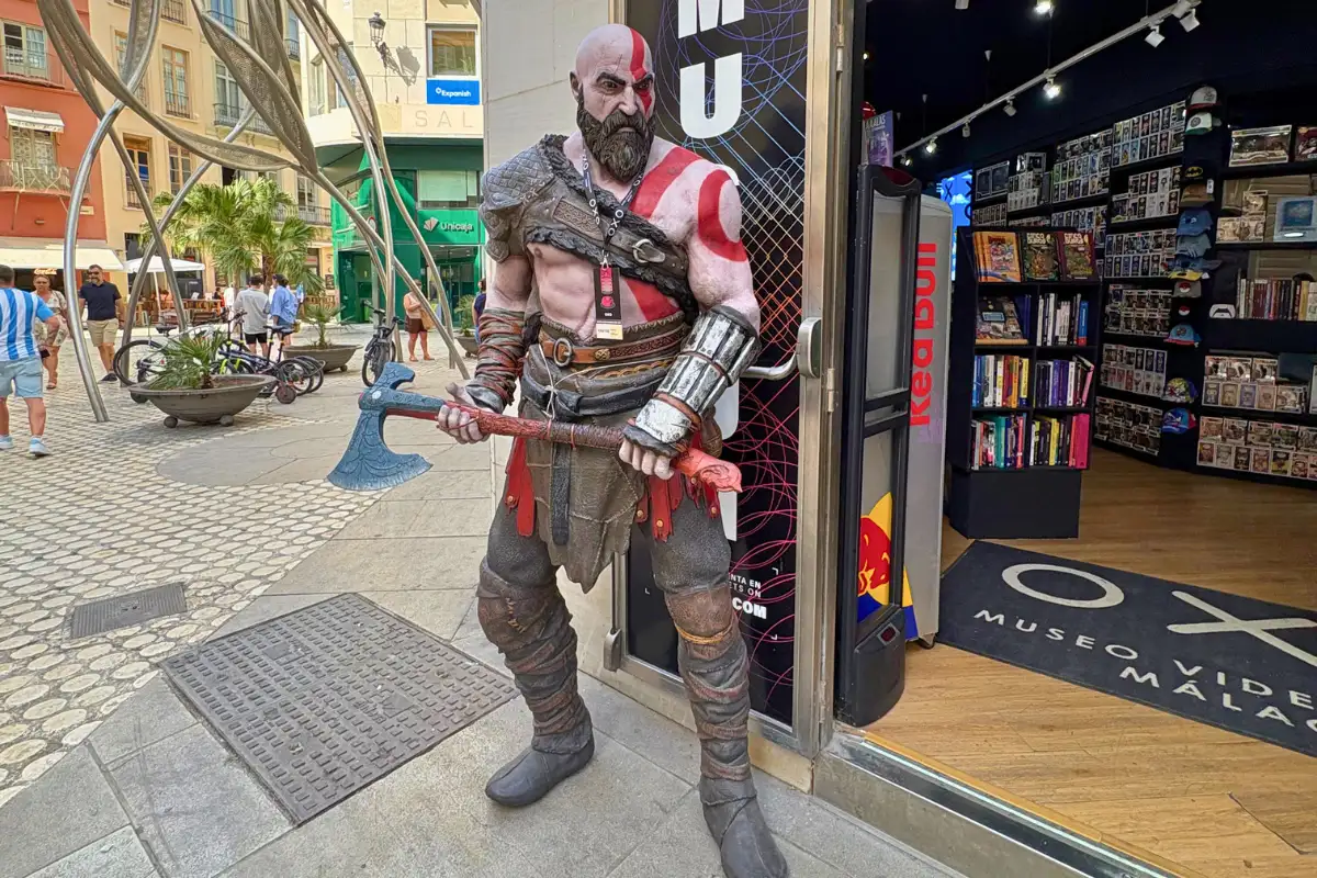 God of War Kratos costumed mascot outside a game shop on a Malaga street