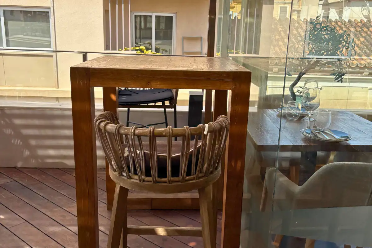 High wooden table and stool on the open terrace at Terraza Catedral in Malaga