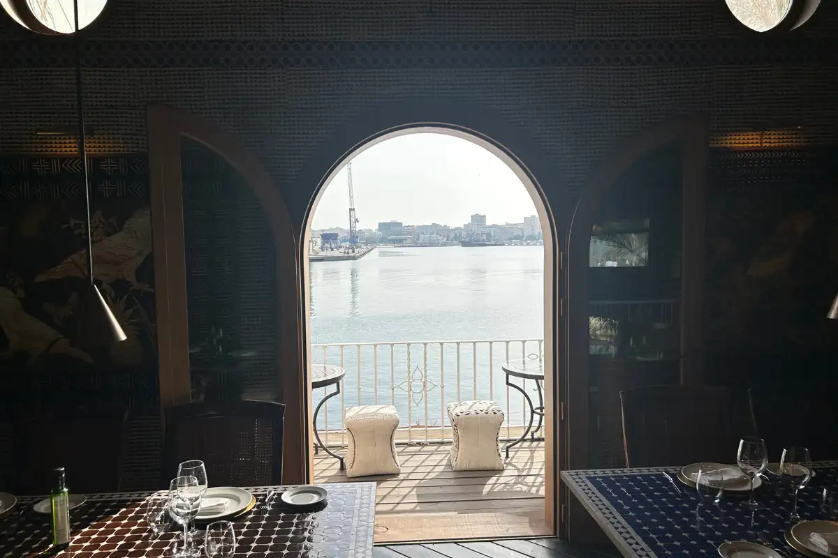 Arched doorway framing the harbour view from the dining room at Trocadero de Las Botes in Malaga