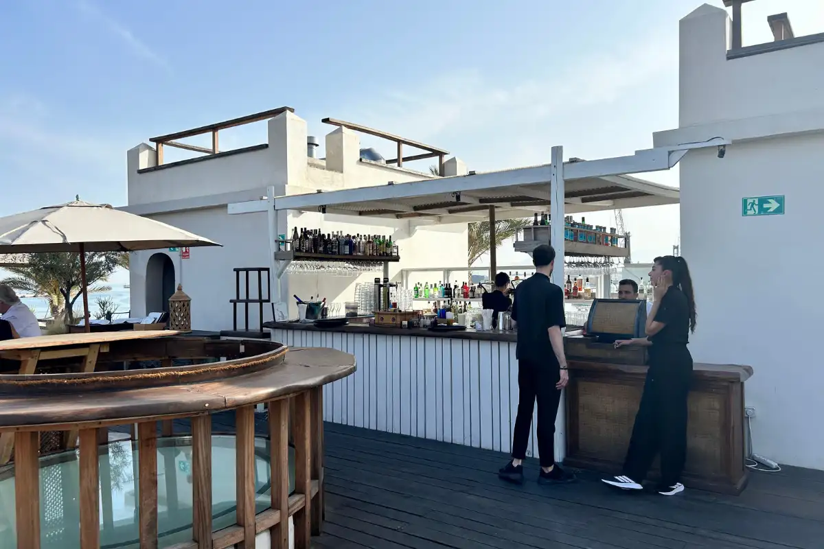 Staff at the rooftop bar counter on the decked terrace at Trocadero de Las Botes in Malaga