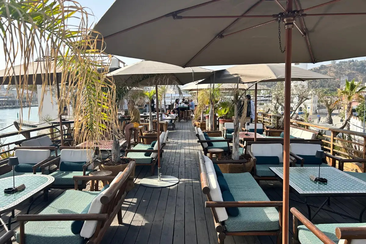 Rows of sunloungers and parasols on the decked terrace at Trocadero de Las Botes in Malaga