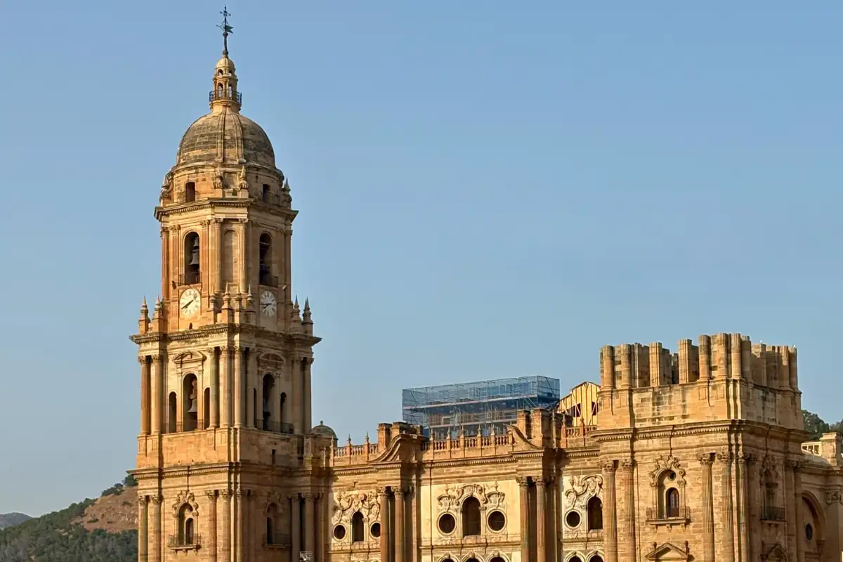 Malaga Cathedral tower lit by golden light seen from Vincci Larios Diez rooftop