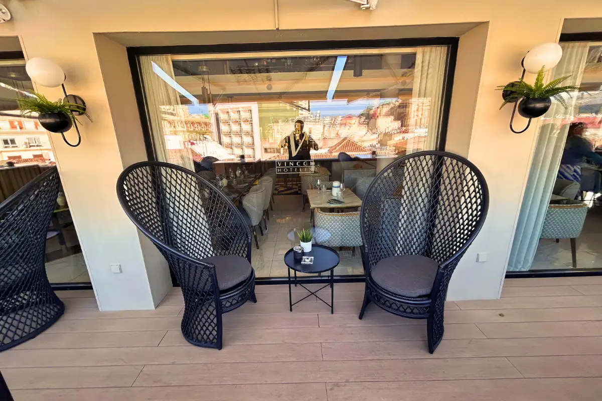 Woven armchairs and side table on the terrace overlooking Malaga at Vincci Larios Diez