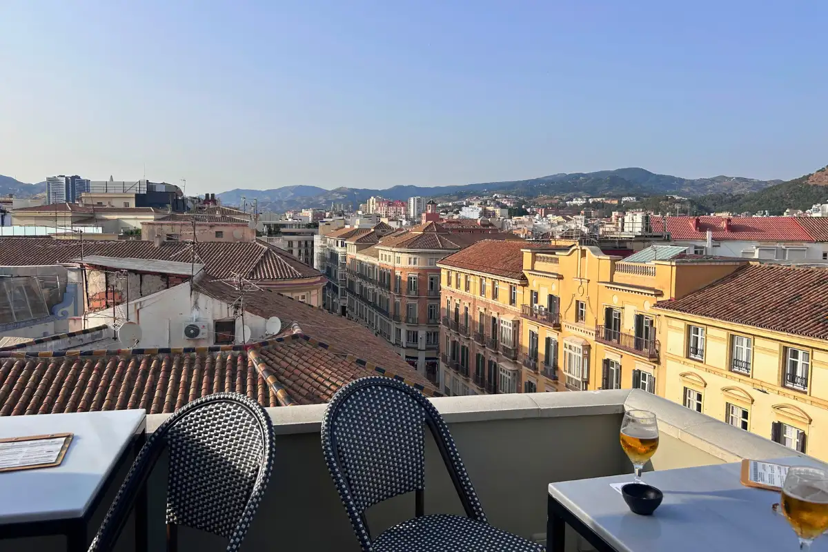 Rooftop terrace table with drinks and rooftop views over Malaga at Vincci Larios Diez