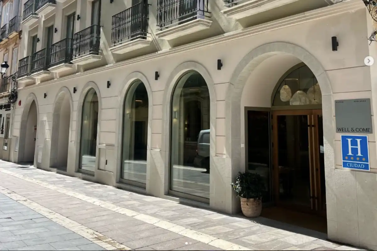 Arched old town facade of Well and Come hotel in Malaga