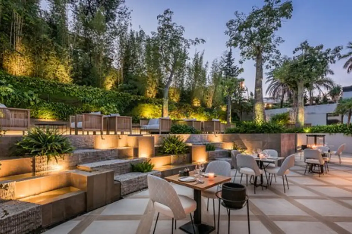 Tiered garden terrace lit up at night at Air by Breathe Marbella